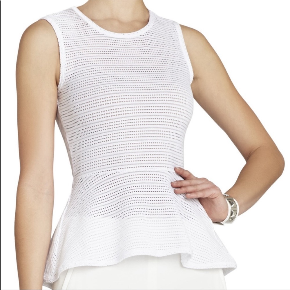 BCBGMaxAzria Light pink perforated peplum top.